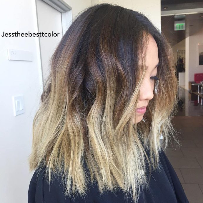 wavy lob with dark roots and blonde highlights