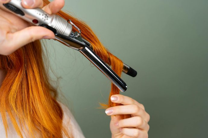 Curling Women Hair with a Flat Iron